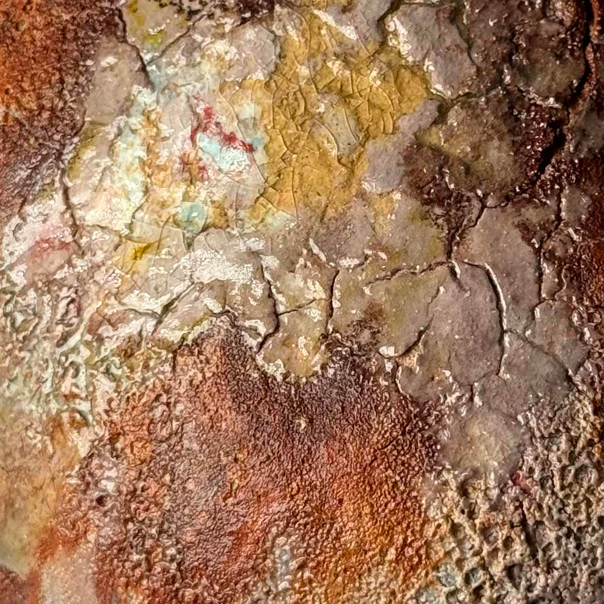 Close-up of rustic ceramic vase with green and brown patina