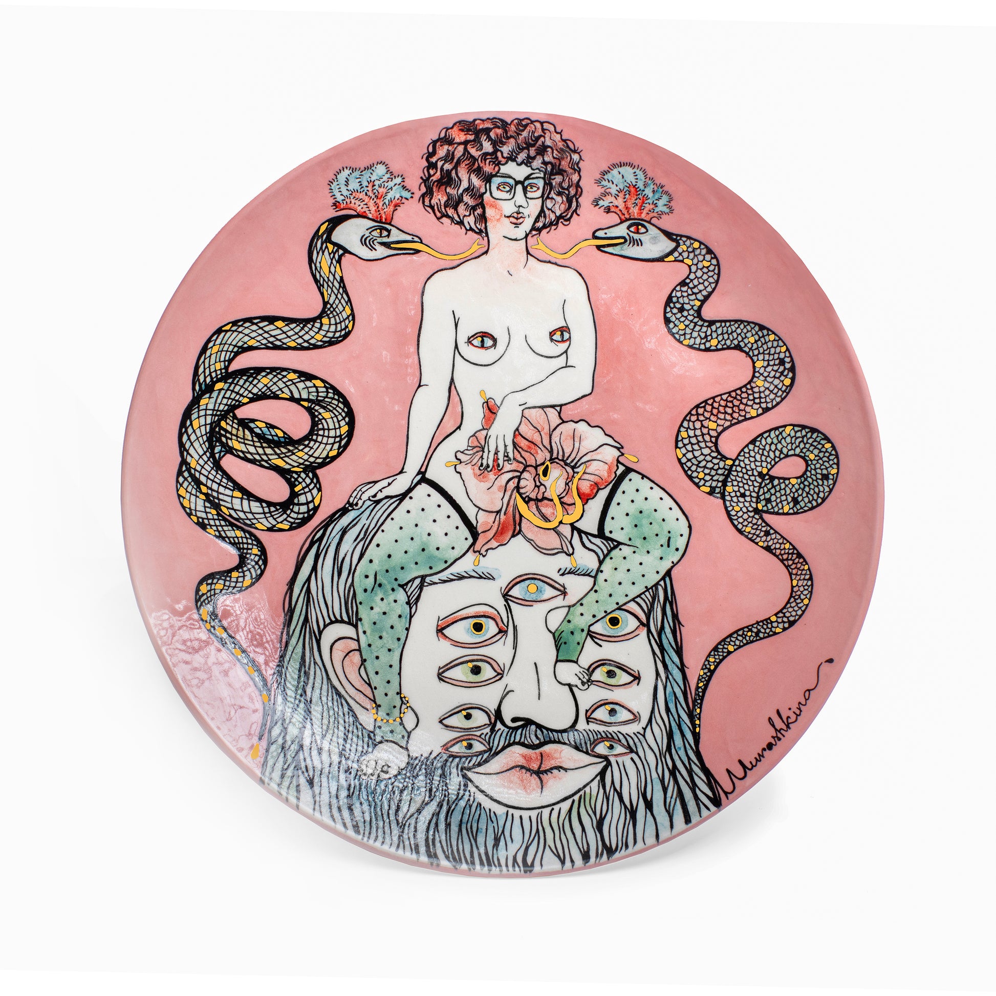 Decorative plate with artistic design of a woman with snakes and a face on a pink background