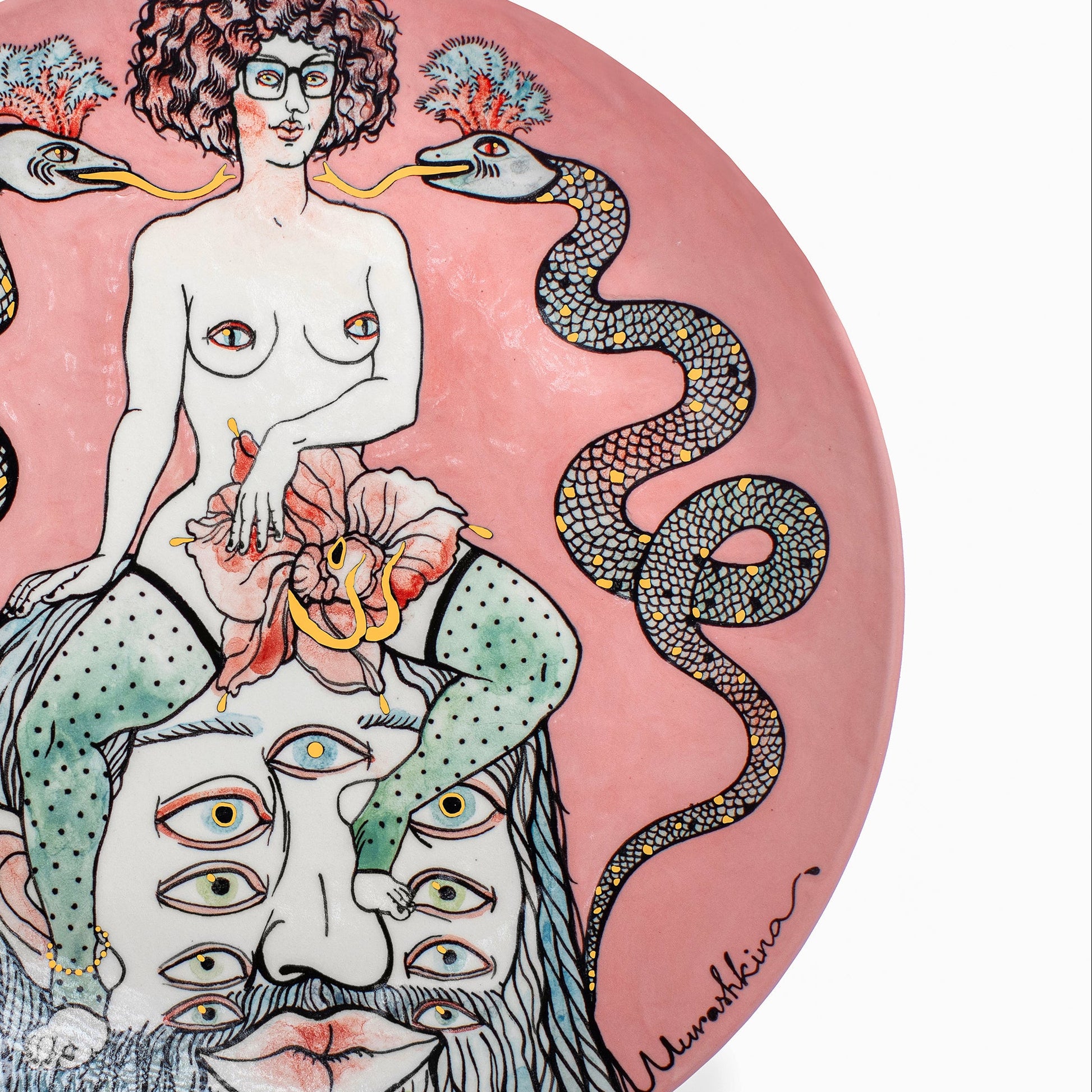Decorative plate with artistic design of a woman with snakes and a face on a pink background