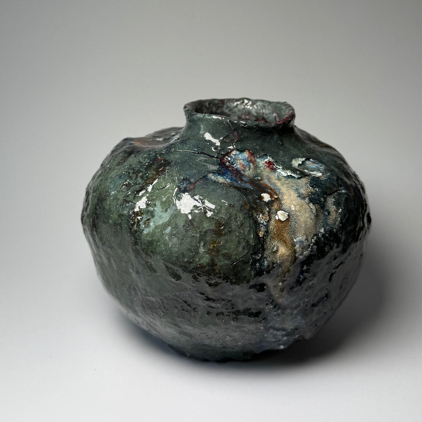 Ceramic vase with textured surface on a gray background