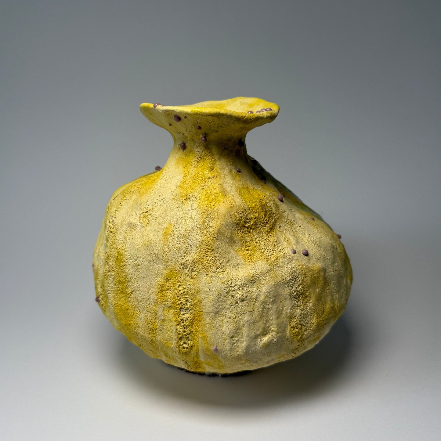 Yellow ceramic interior vase on a gray background