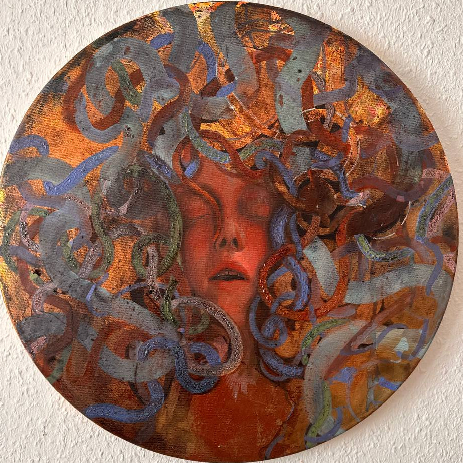 Meduza, artwork with a stylized face and swirling patterns on a white wall.