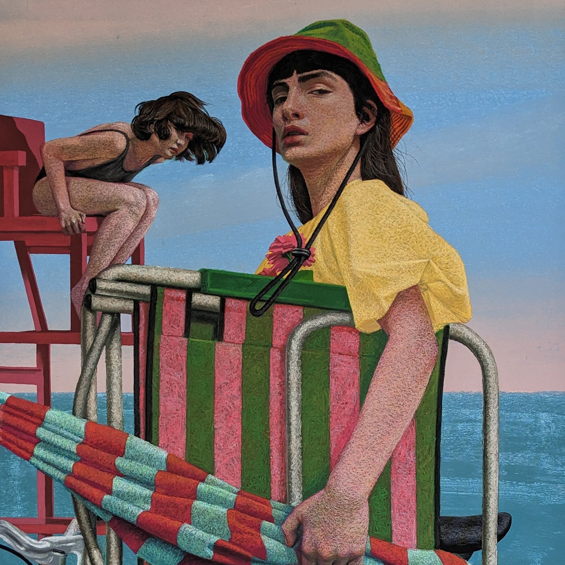 Person with a bicycle and striped chair at the beach