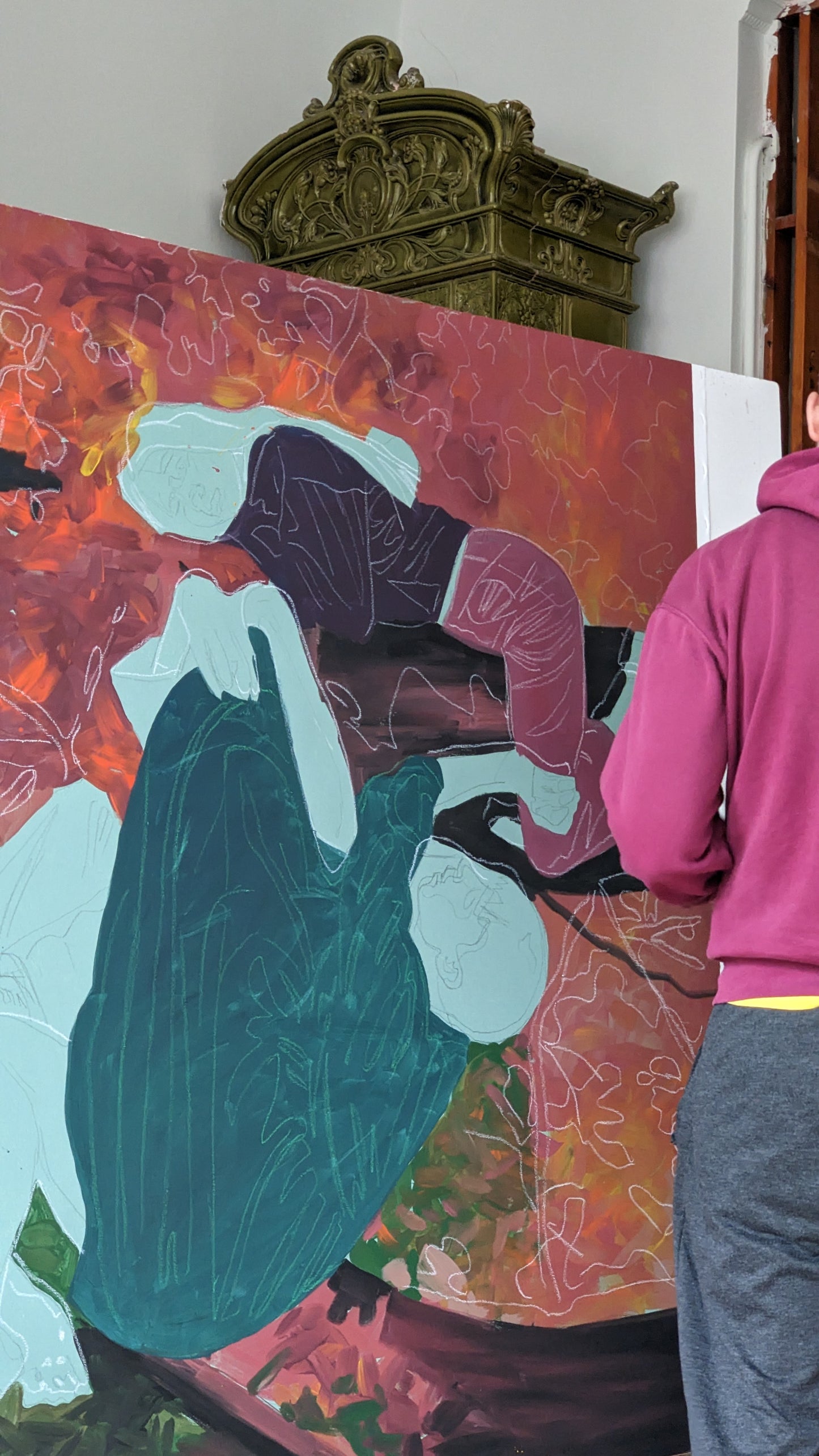 Person standing in front of a colorful abstract painting