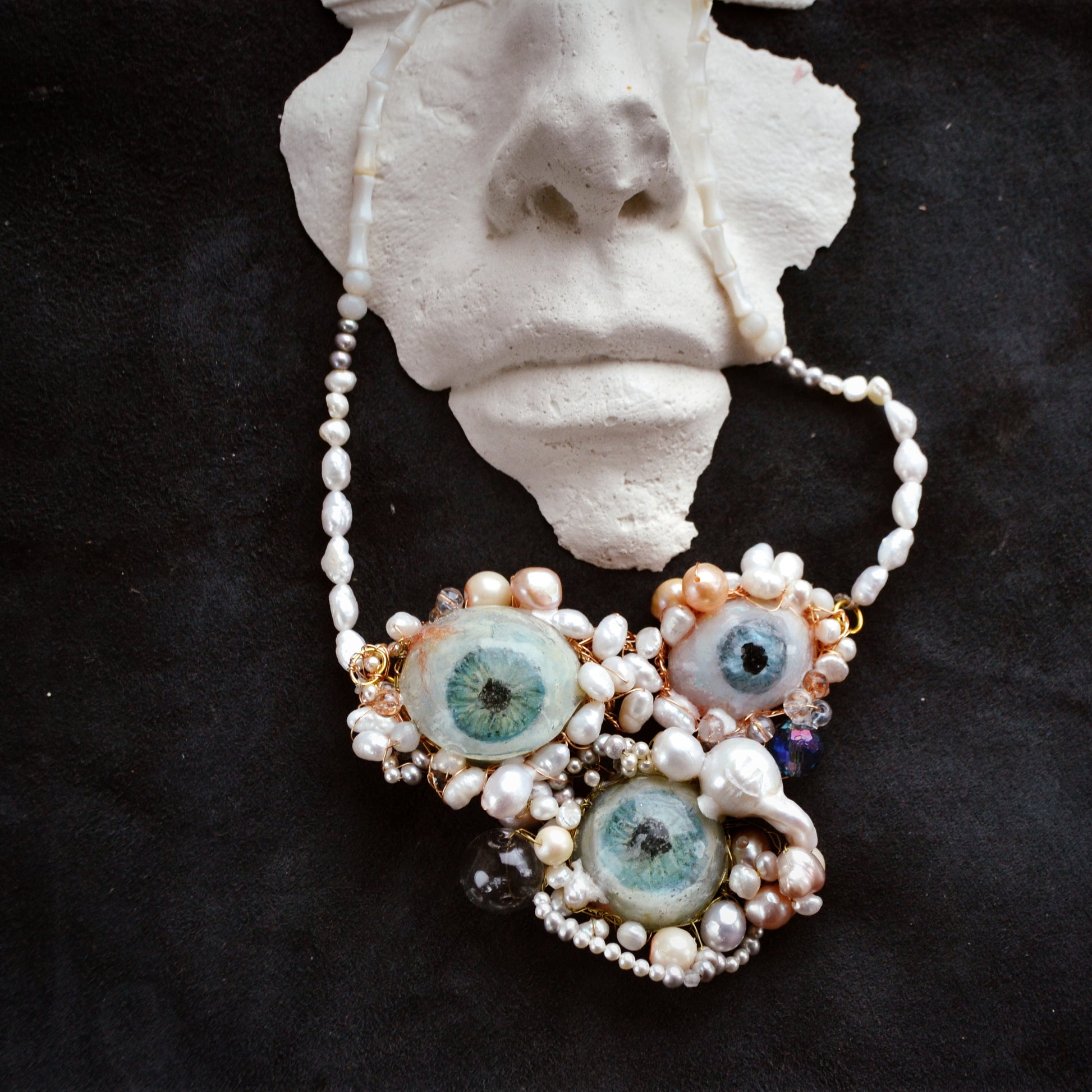 Necklace with owl-shaped pendants on a dark background