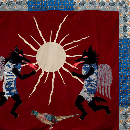 Decorative fabric panel with sun design, winged creatures, and a bird on a red background.