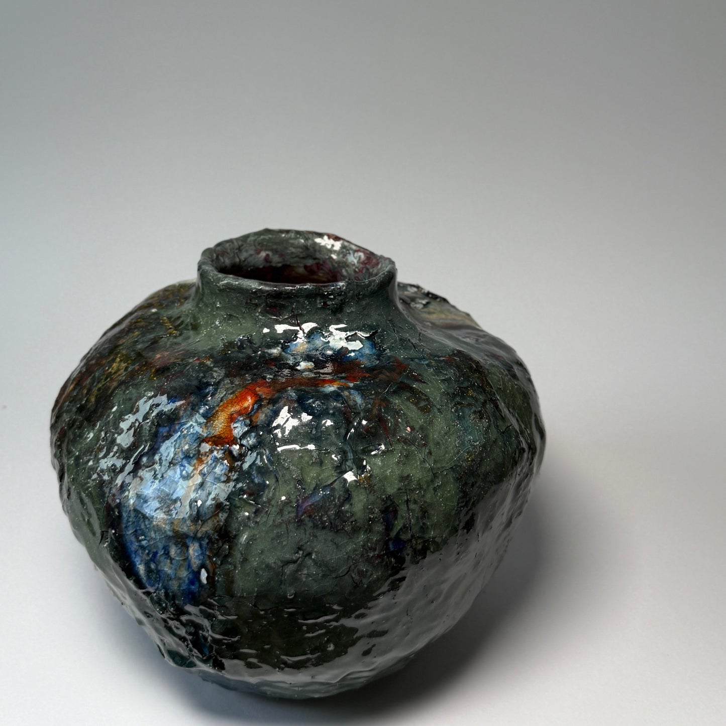 Green interior ceramic vase on a gray background