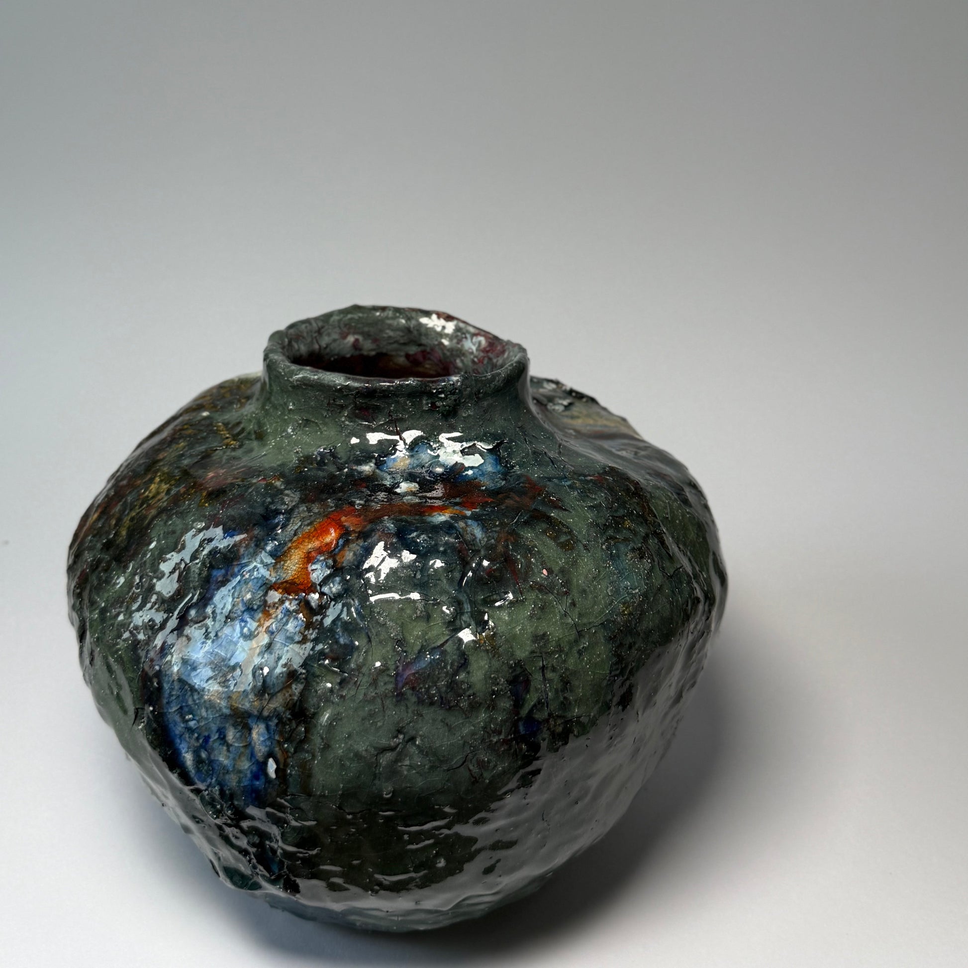 Green interior ceramic vase on a gray background