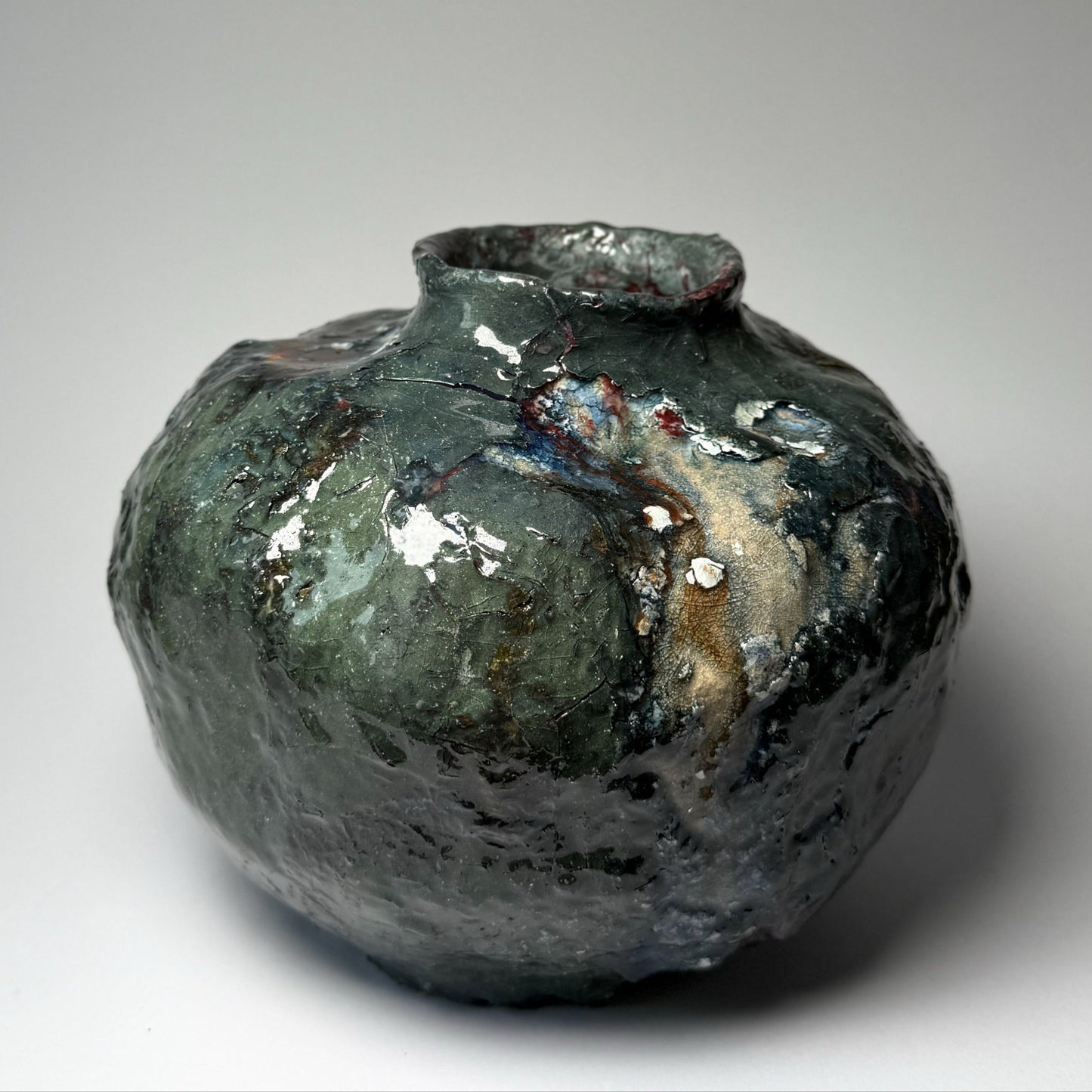 Decorative ceramic vase with a textured surface on a plain background