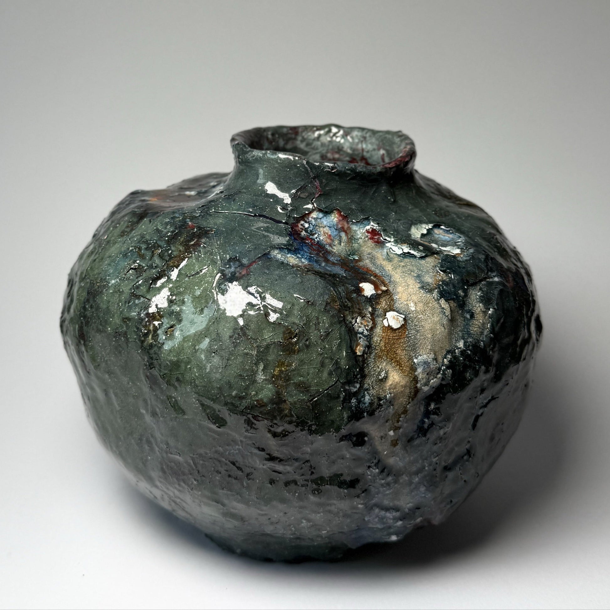 Decorative ceramic vase with a textured surface on a plain background