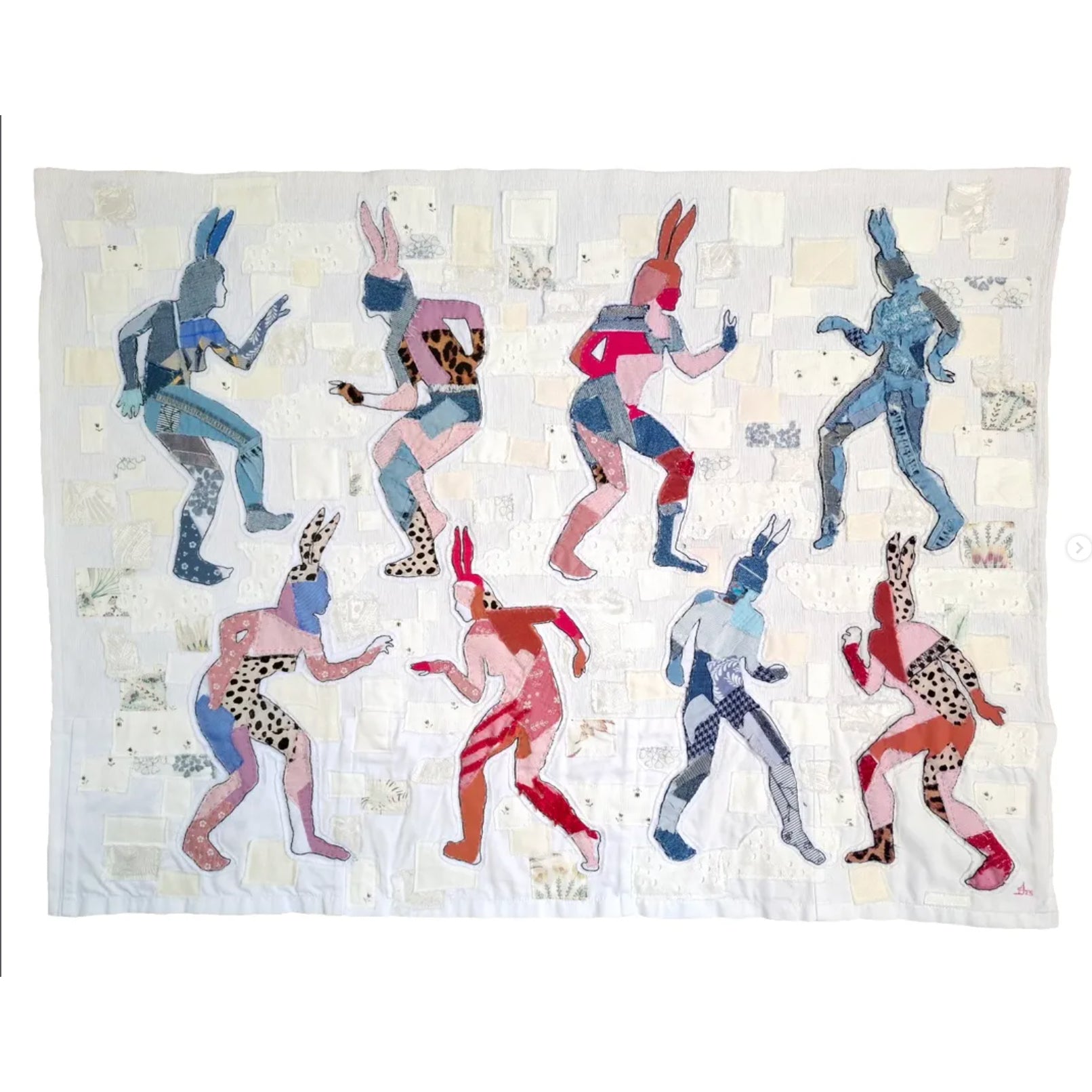 Quilt with colorful abstract figures on a white background