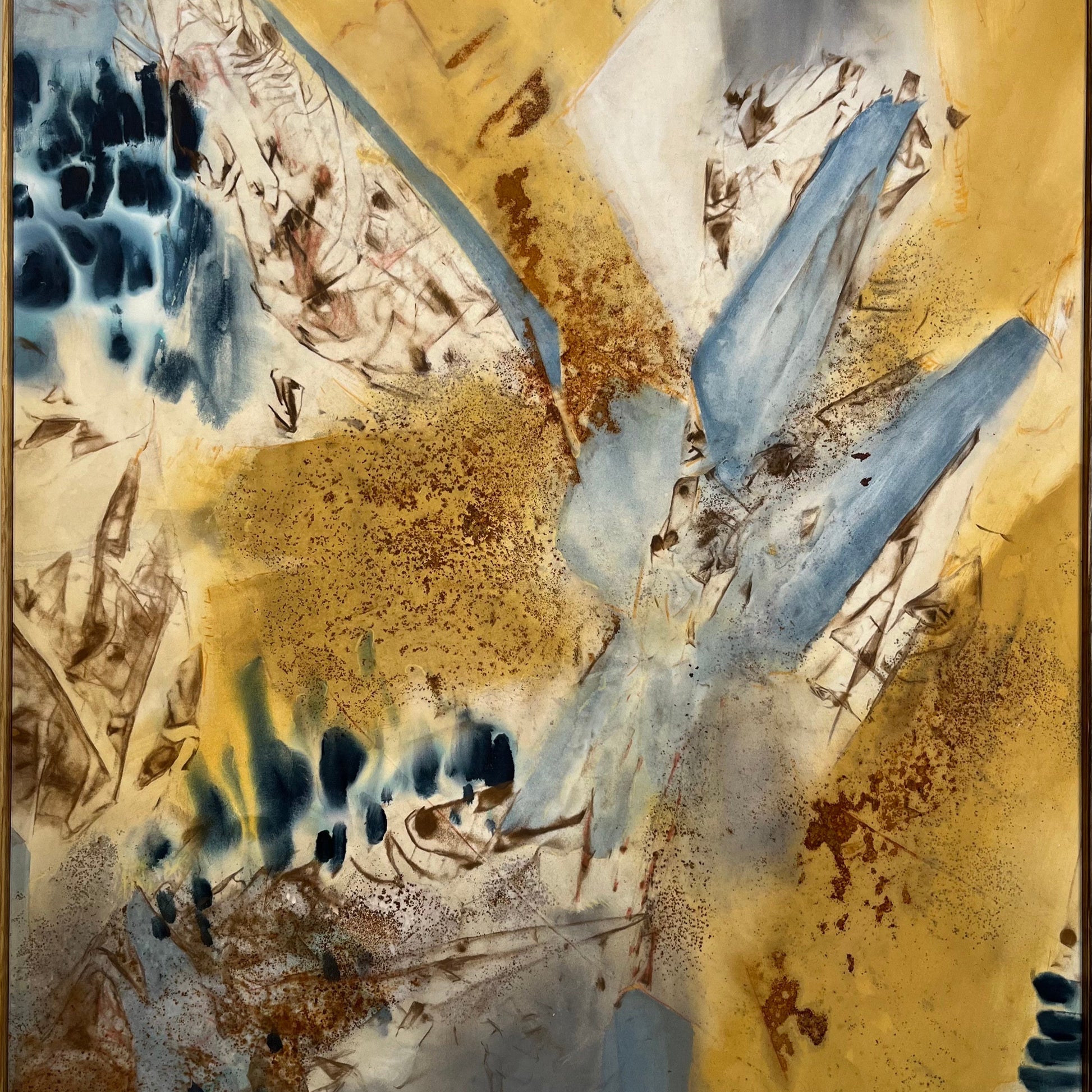 Abstract artwork featuring a blend of gold, blue, and beige tones with dynamic textures and a signature in the upper right corner.