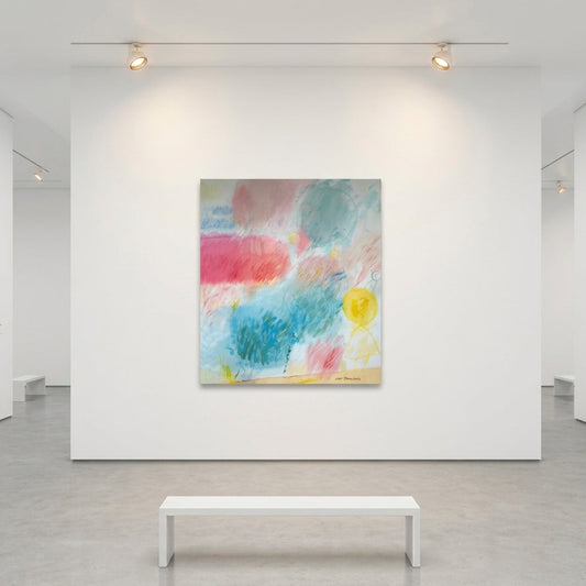 An abstract painting with pastel pink, blue, teal, and yellow brushstrokes displayed on a white gallery wall, with a white bench below and gallery walls on both sides.