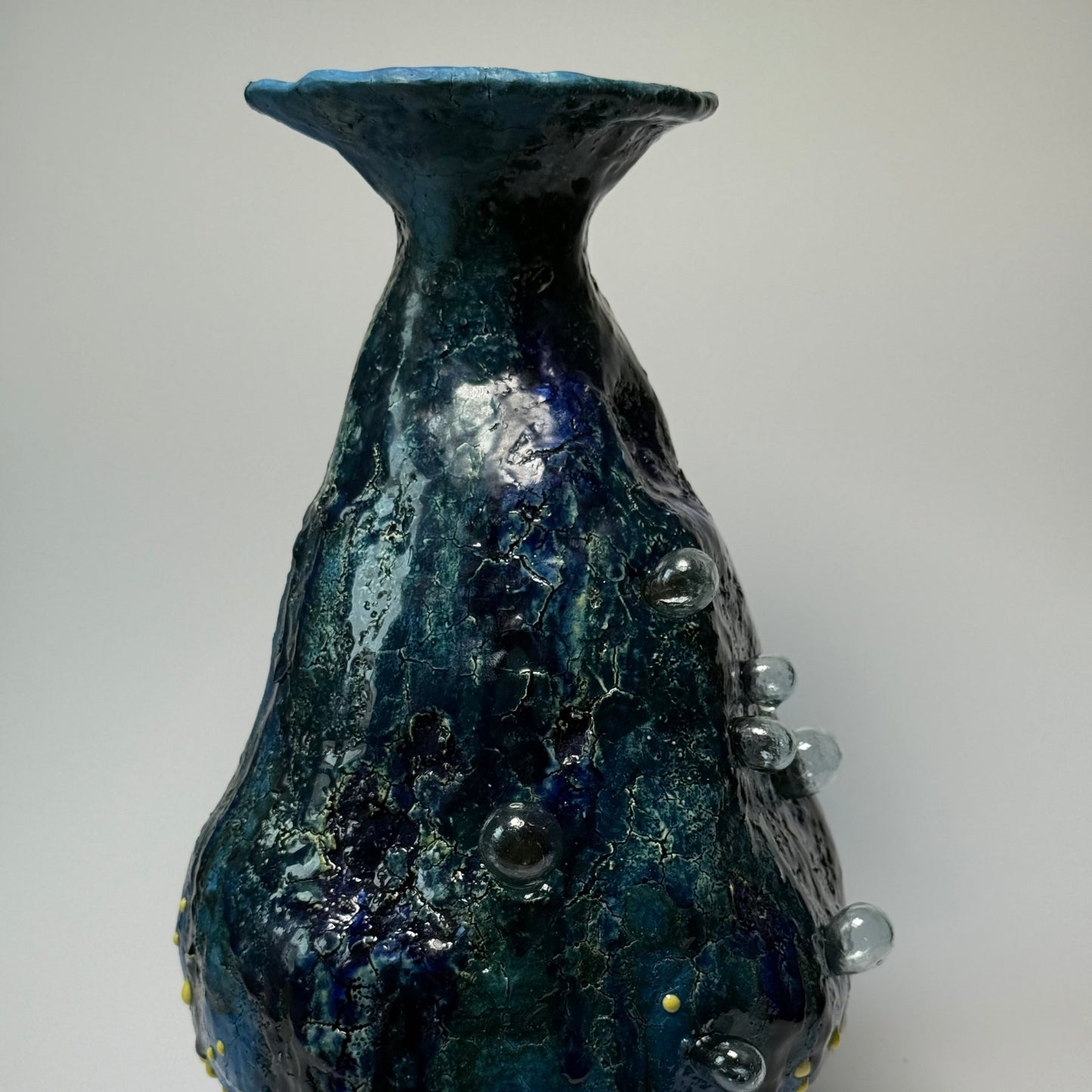 Blue textured interior vase on a gray background