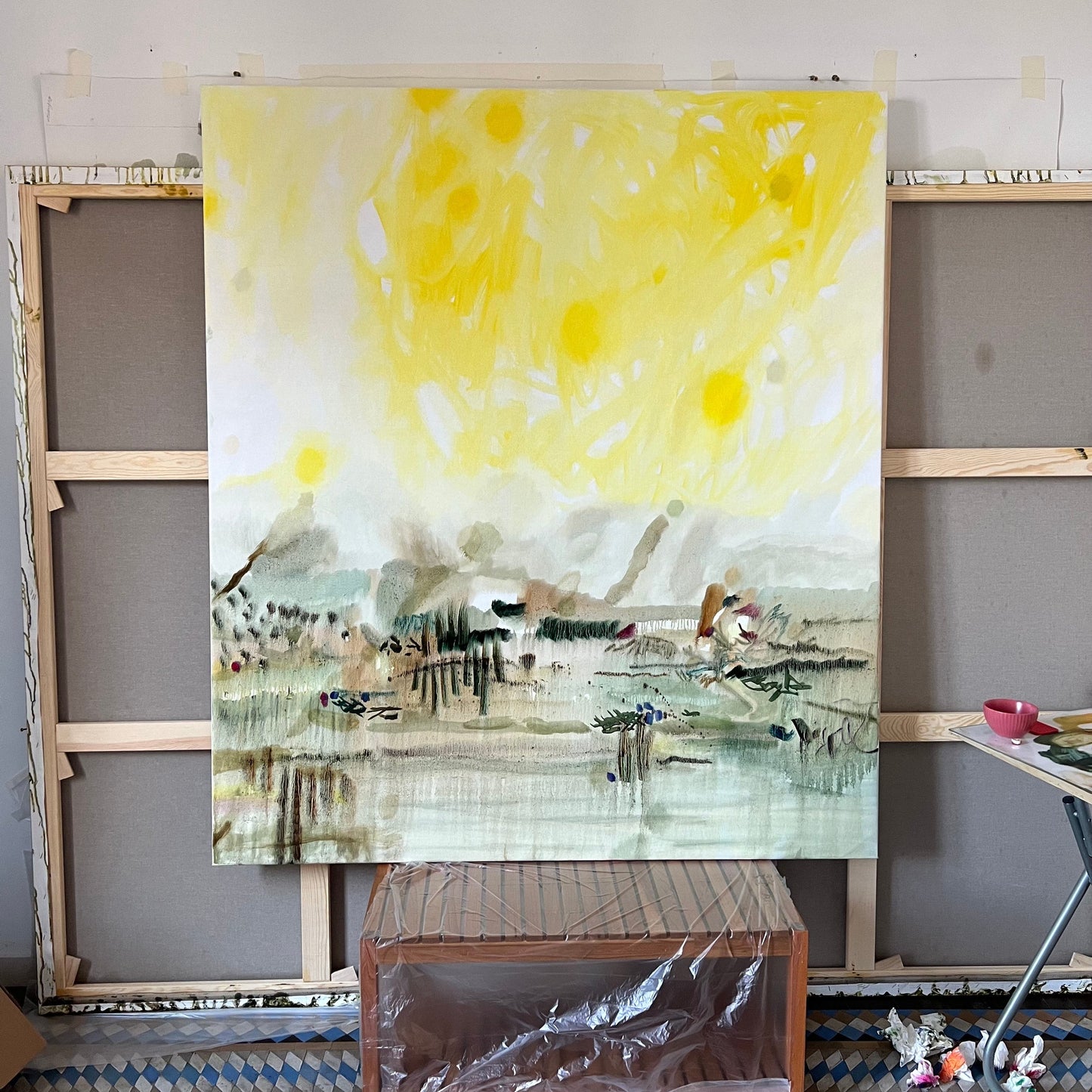 A canvas painting titled 'Light' by Vera Tolmacheva, displayed on an easel with a backdrop of a white wall. The painting features abstract and contemporary art elements with a vibrant use of color.