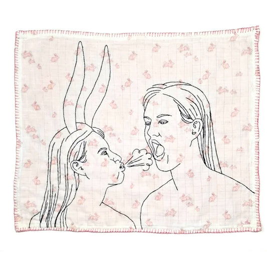 Blanket with line art of two women blowing bubbles on a floral patterned background