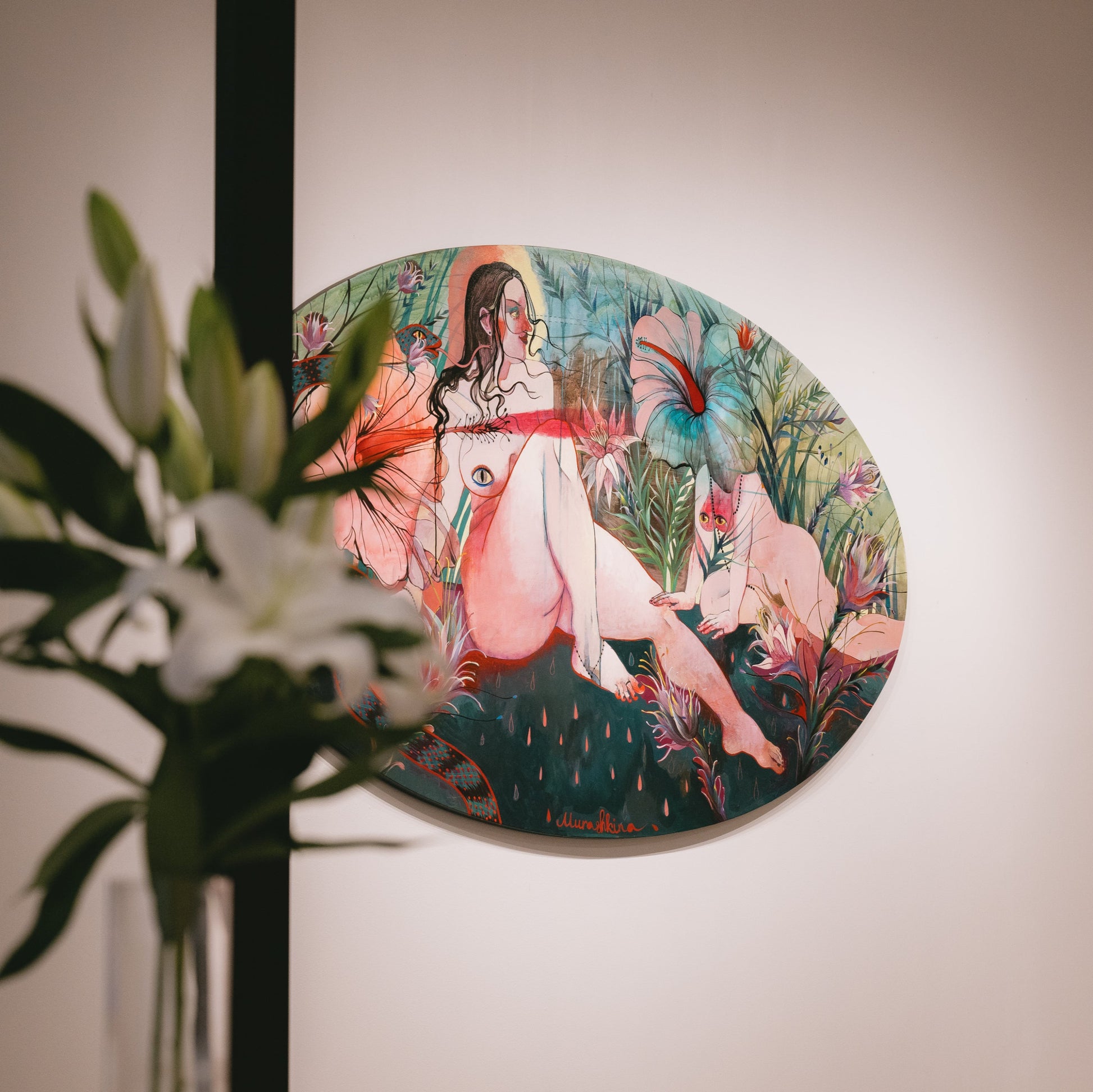 Nina Murashkinan's painting on a wall with a plant in the foreground. photo by Dinara Khairova