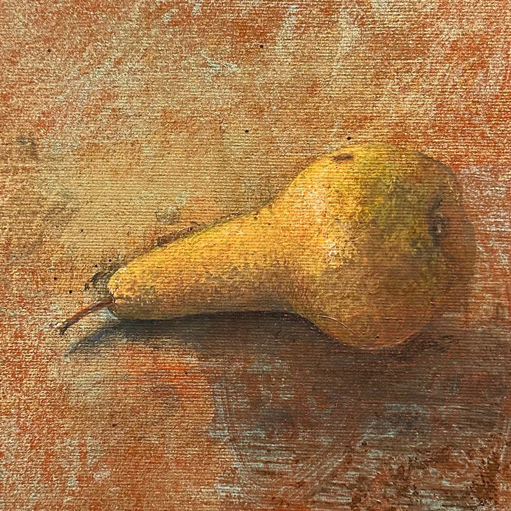Pear on a textured surface with a warm color palette, close up