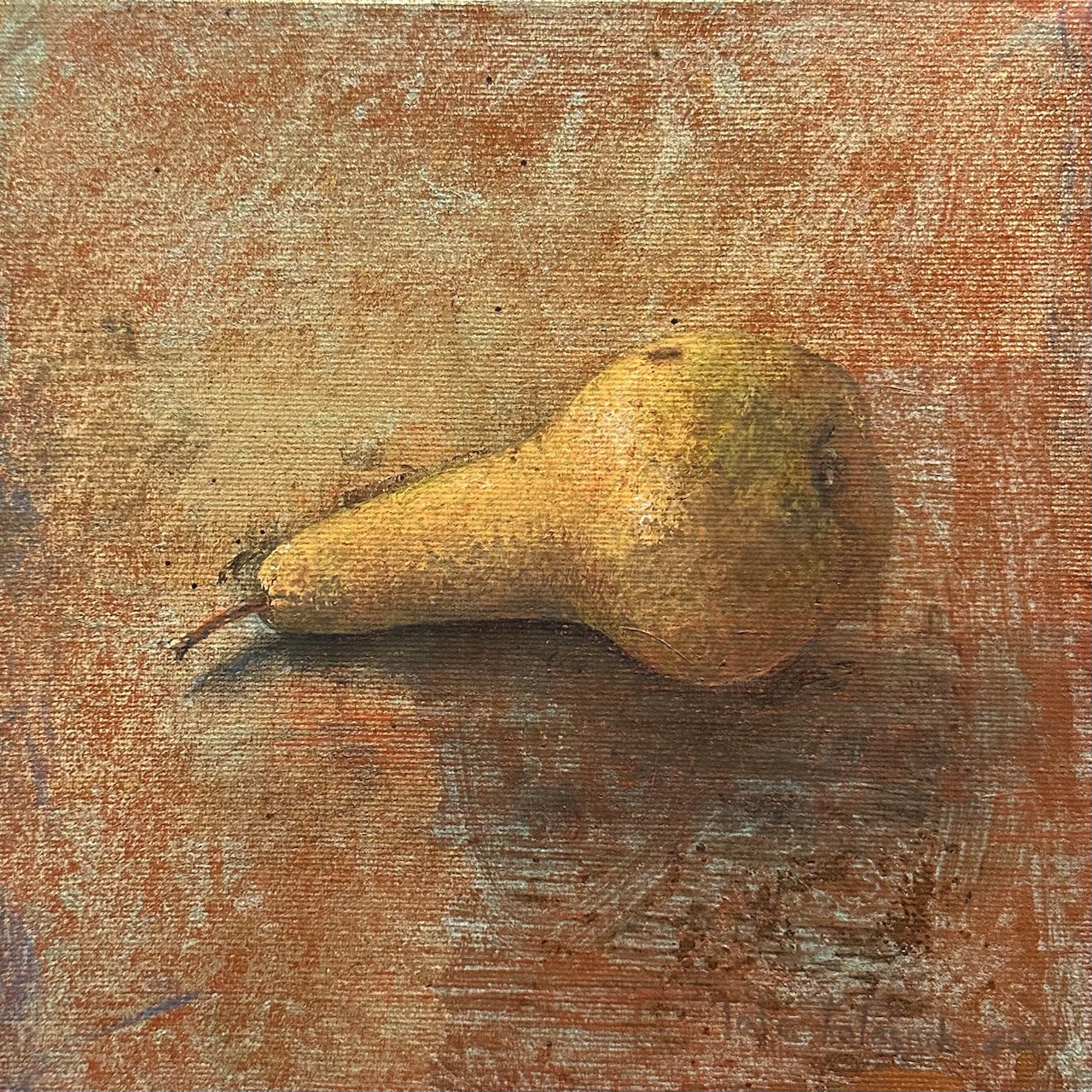 Pear on a textured surface with a warm color palette