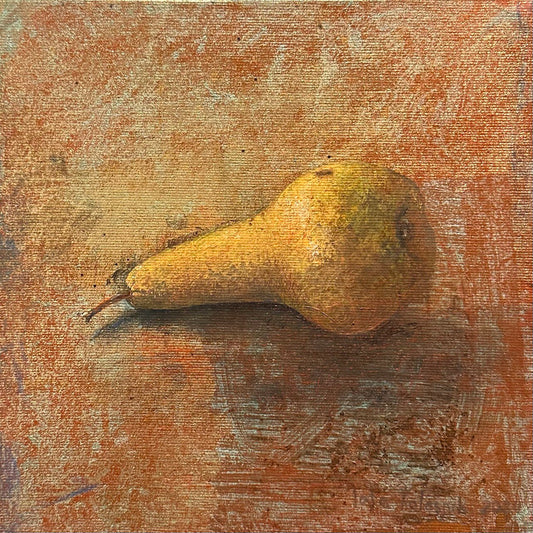 Pear on a textured surface with a warm color palette