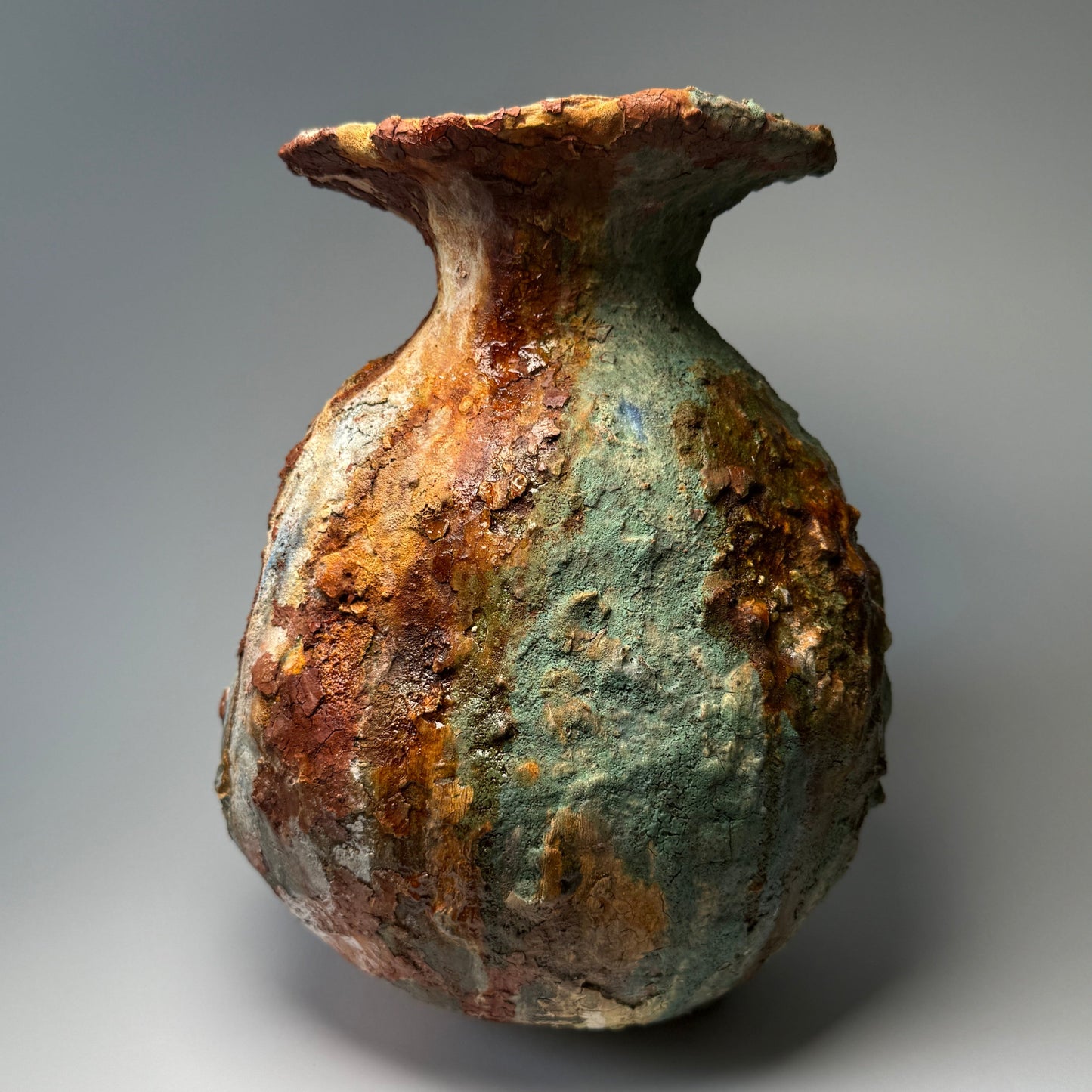 Rust-colored ceramic vase on a gray background, good for Living room