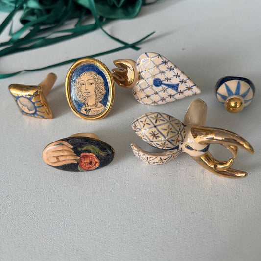 Collection of decorative ceramic rings on a light gray surface